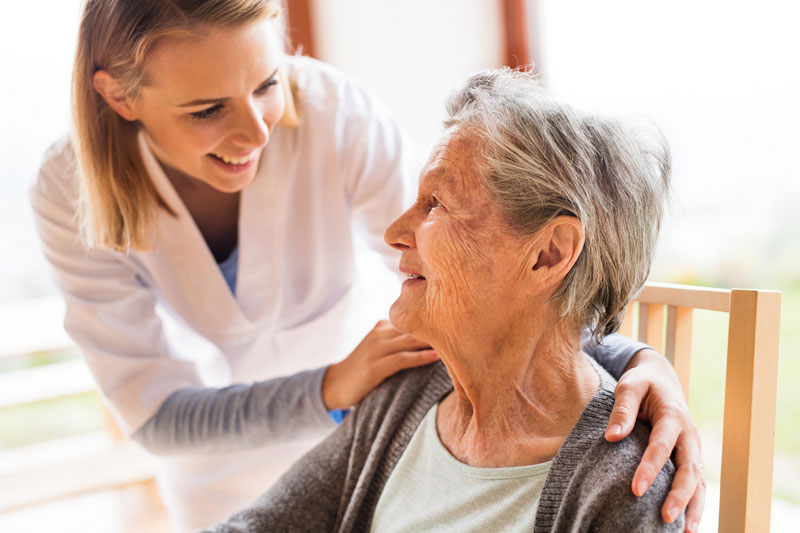 Health visitor and a senior woman during a home visit